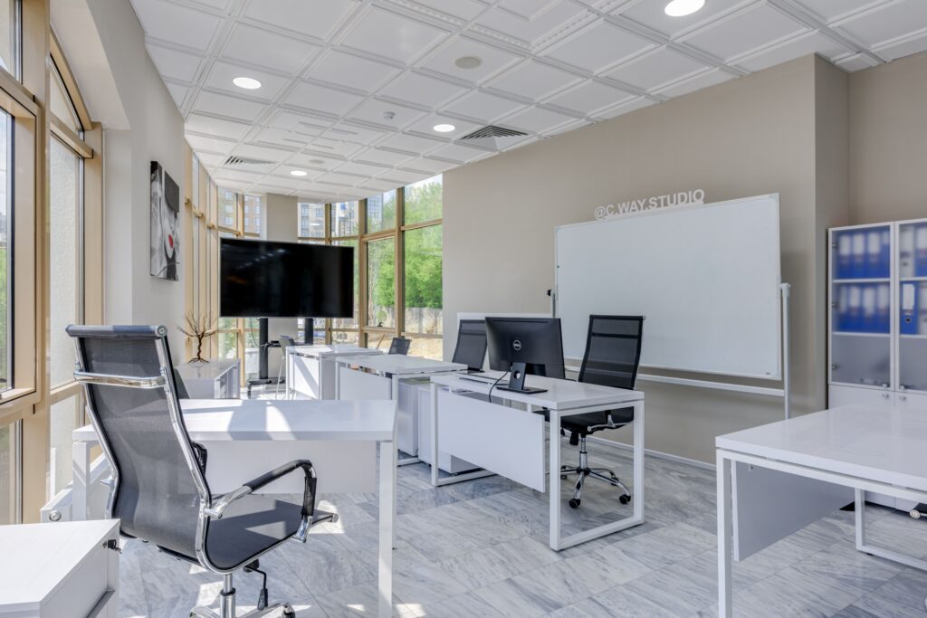 Spacious and bright modern office interior with sleek furniture, ideal for professional workspaces.